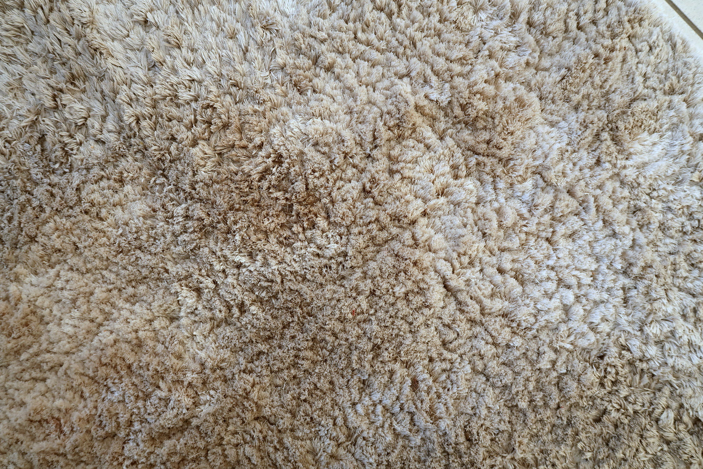 Vintage Flokati style rug close-up, showing plush high-pile surface