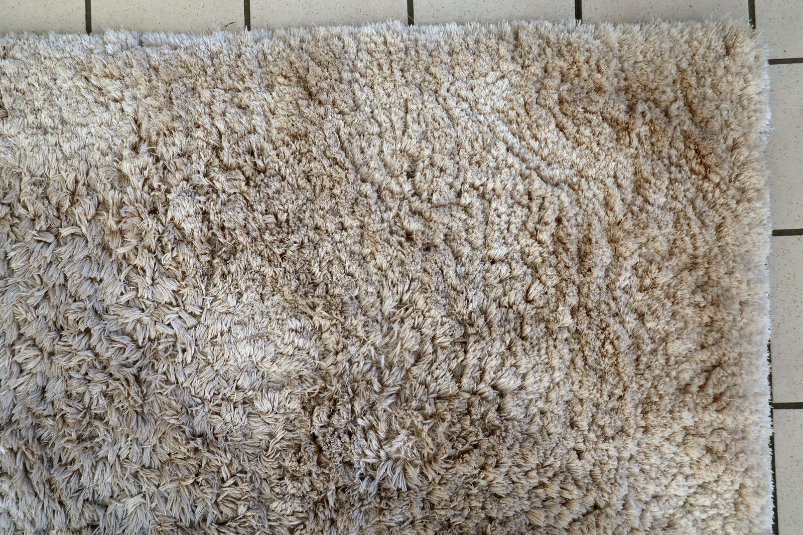 Vintage Flokati style rug close-up, showing plush high-pile surface