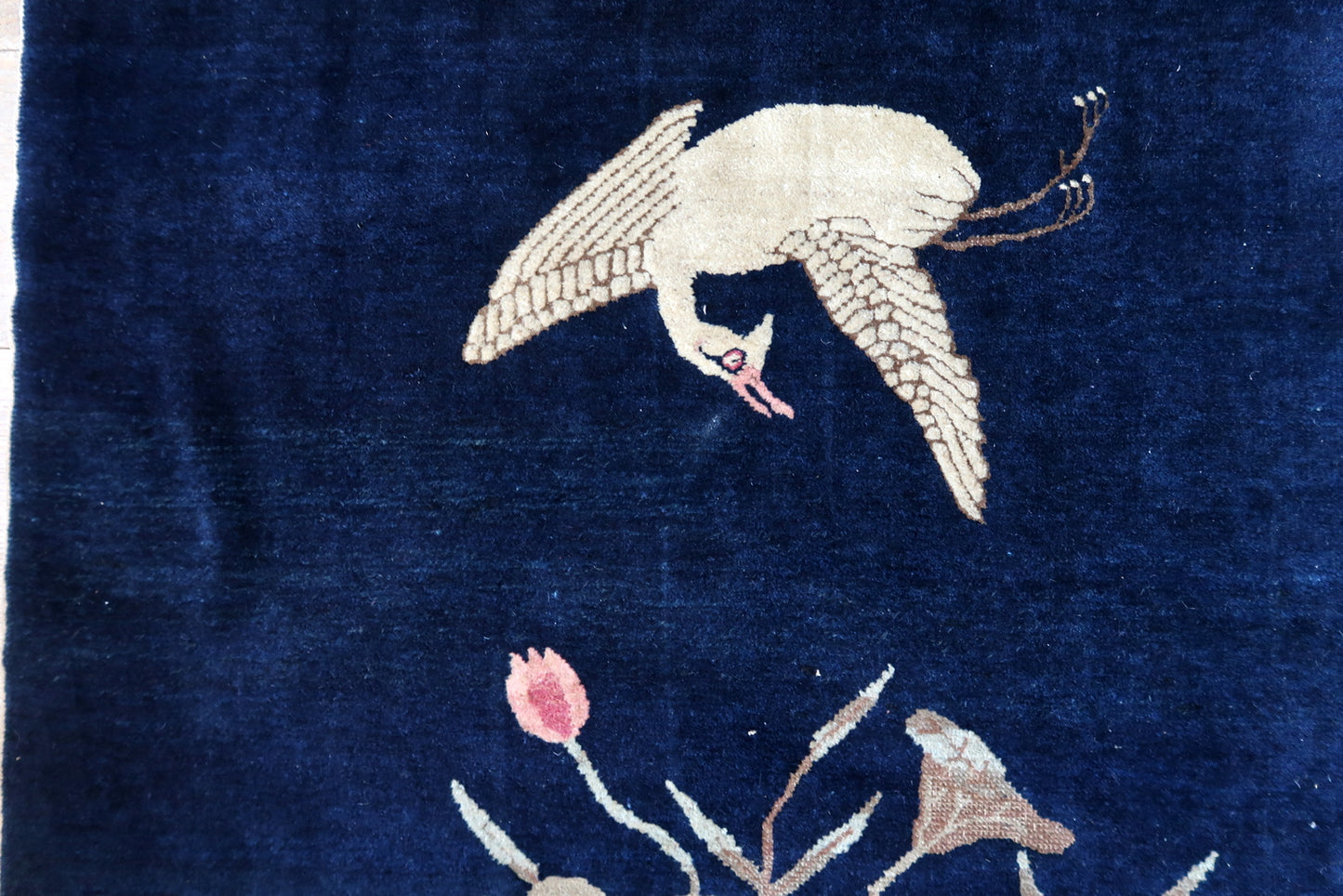 Antique Chinese rug close-up, showing crane motif and hand-knotted texture