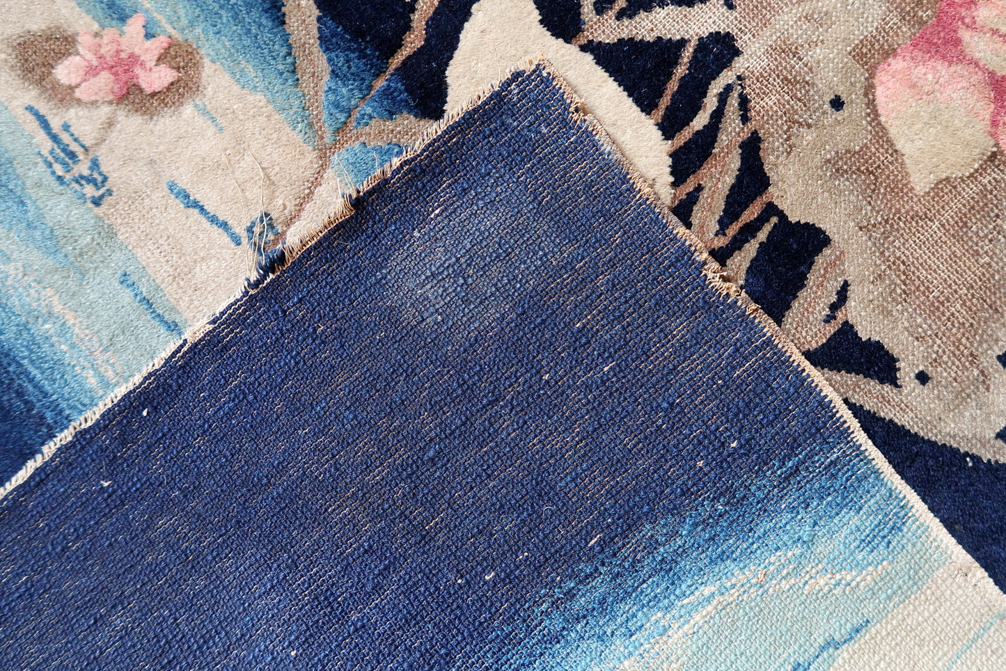 Peking rug texture detail, dense wool pile with soft muted palette