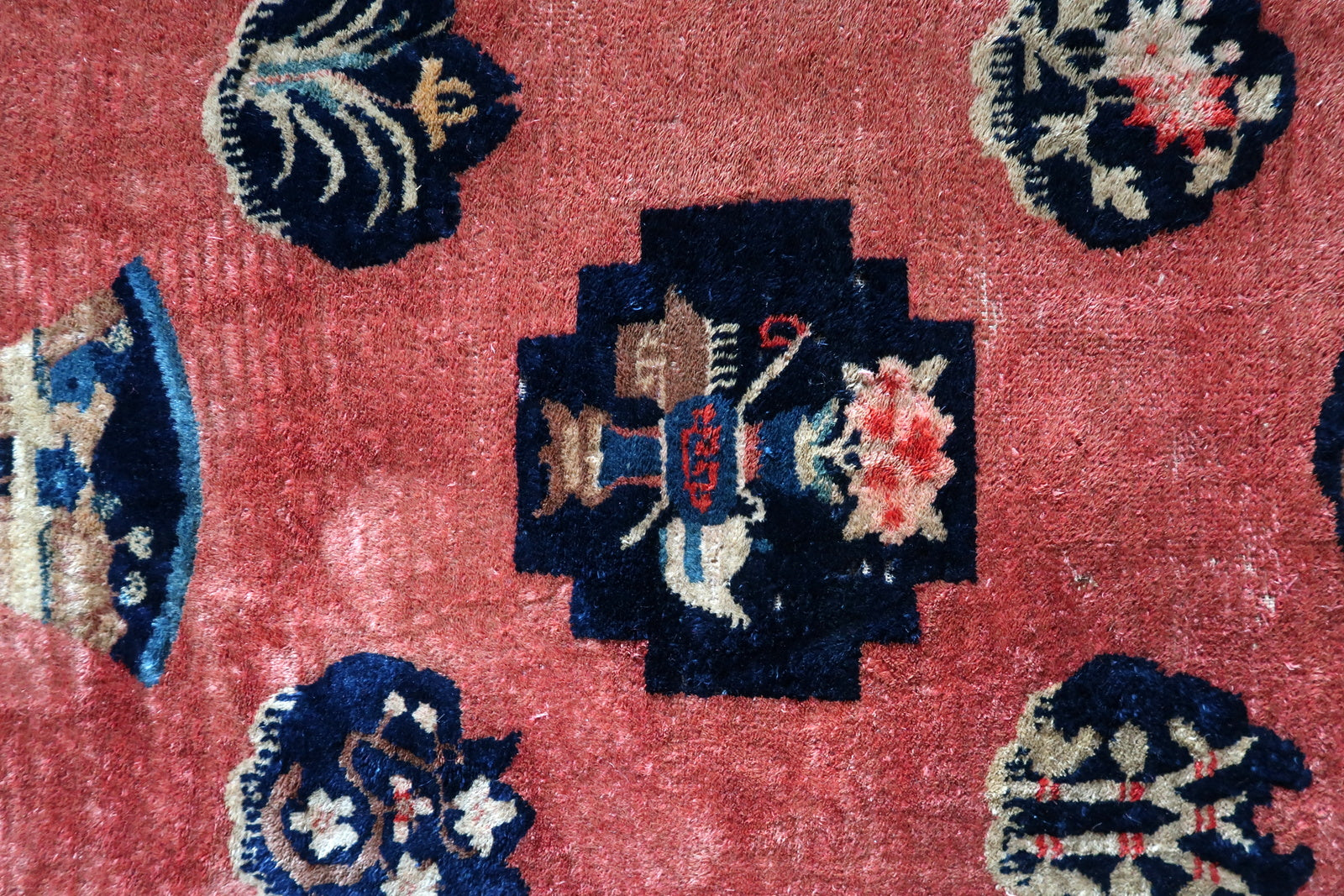 Antique Chinese rug close-up, showing soft wool pile and vibrant colors