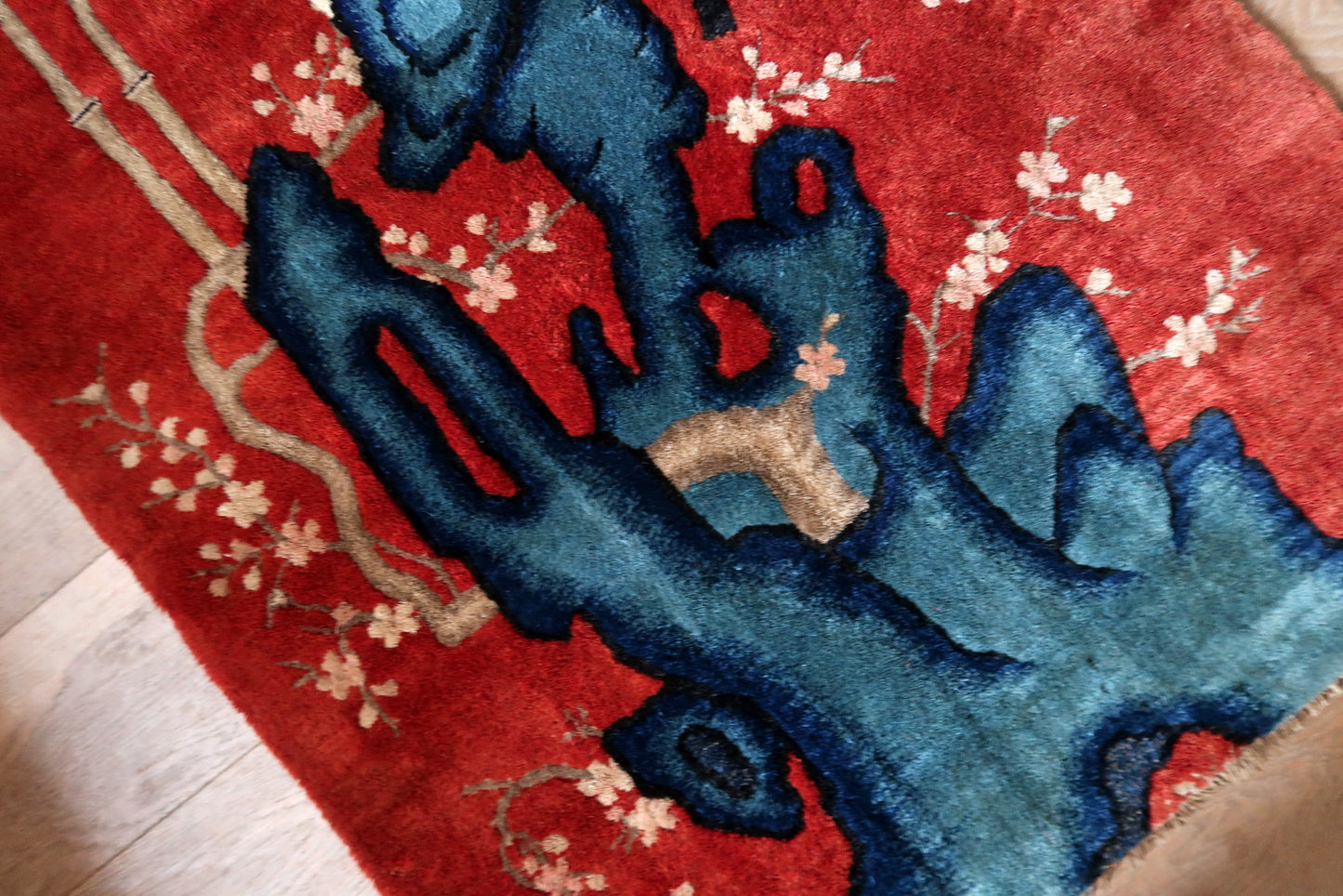 Antique Chinese rug close-up, showing soft wool pile and vibrant colors