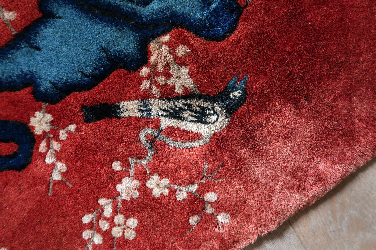 Vintage Chinese wool rug detail, stylized floral and botanical motifs