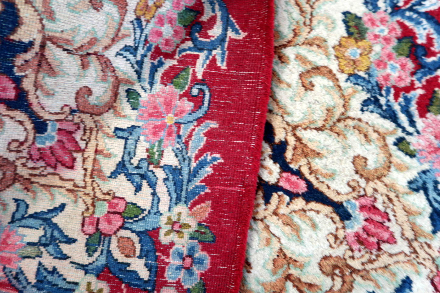 Vintage Kerman rug side view, low pile wool with aged wear and character