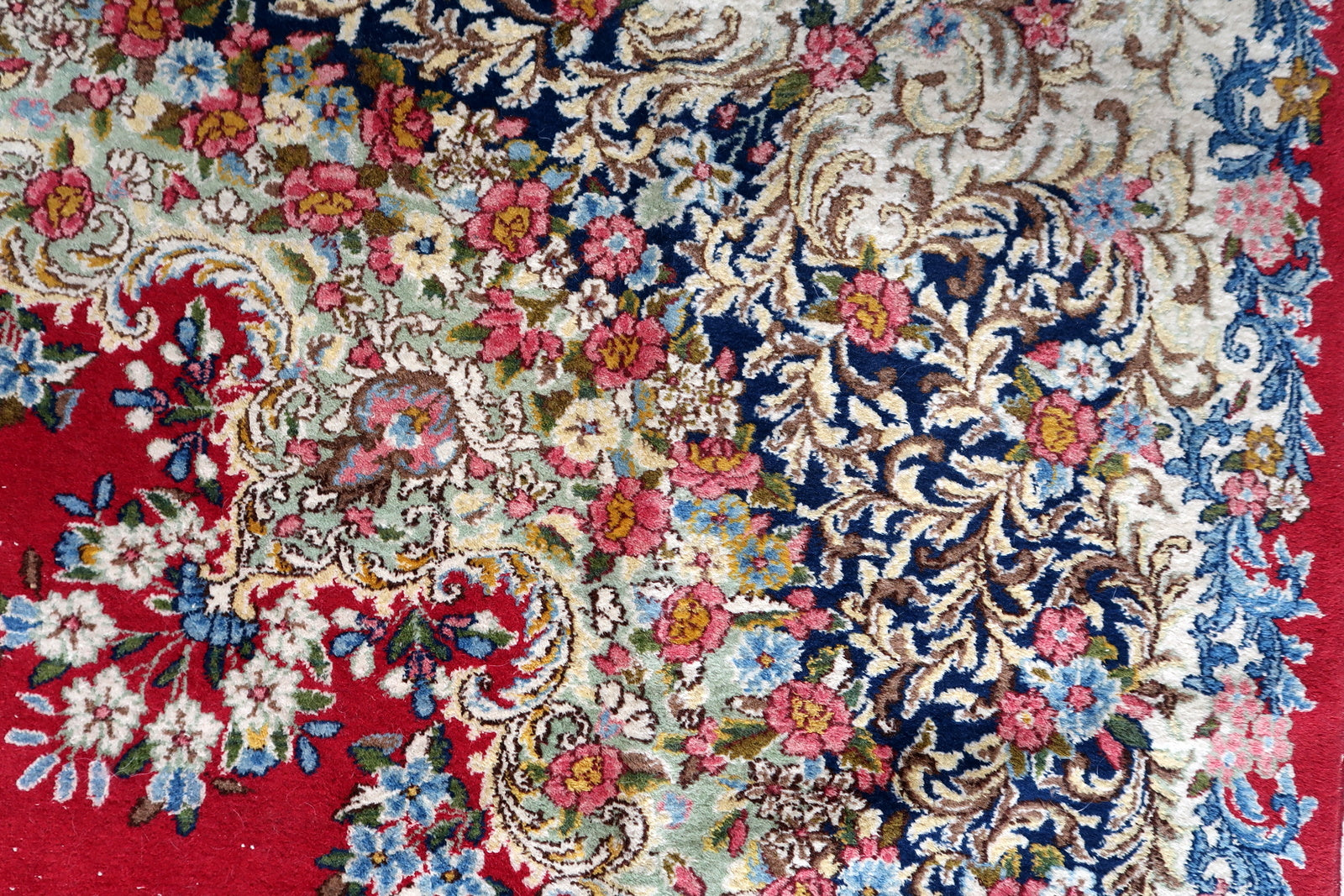 Antique Kerman rug close-up, showing dense wool pile and fine knotting