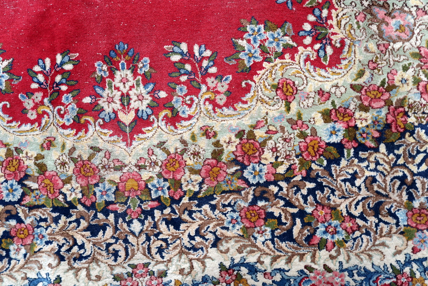 Vintage Persian Kerman rug corner detail, showcasing craftsmanship and patina