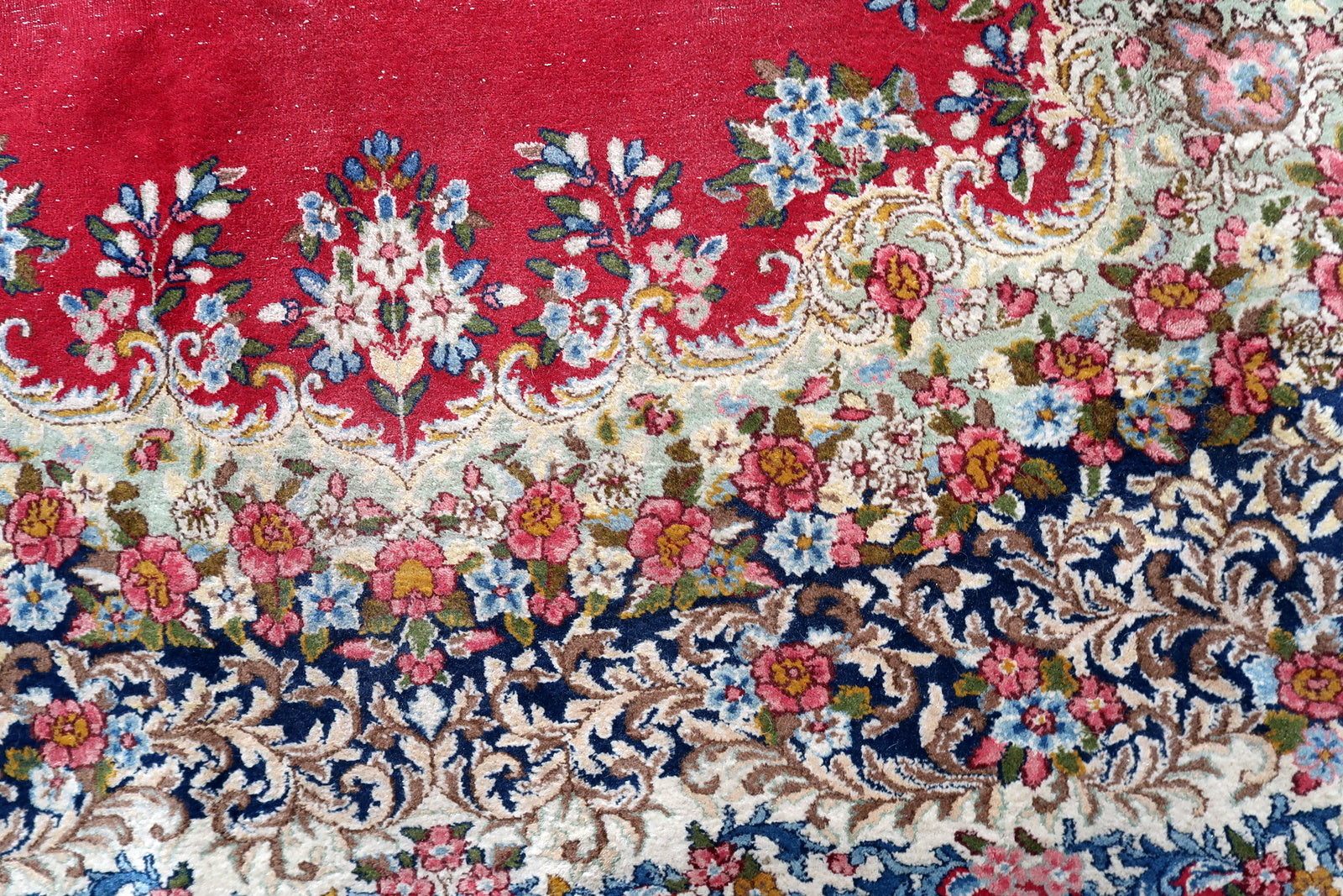 Vintage Persian Kerman rug corner detail, showcasing craftsmanship and patina