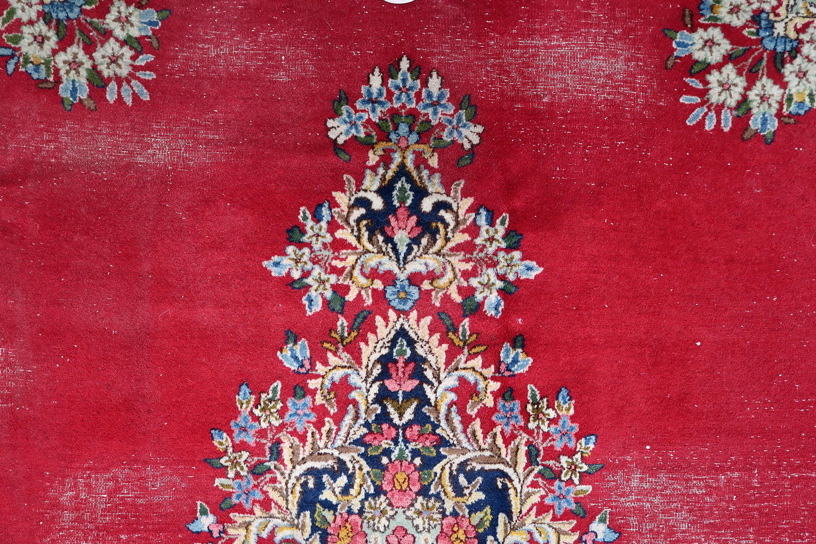 Hand-knotted Kerman rug, red field with detailed floral medallion design