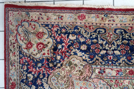 Vintage Persian Kerman rug full view, red field with intricate floral motifs