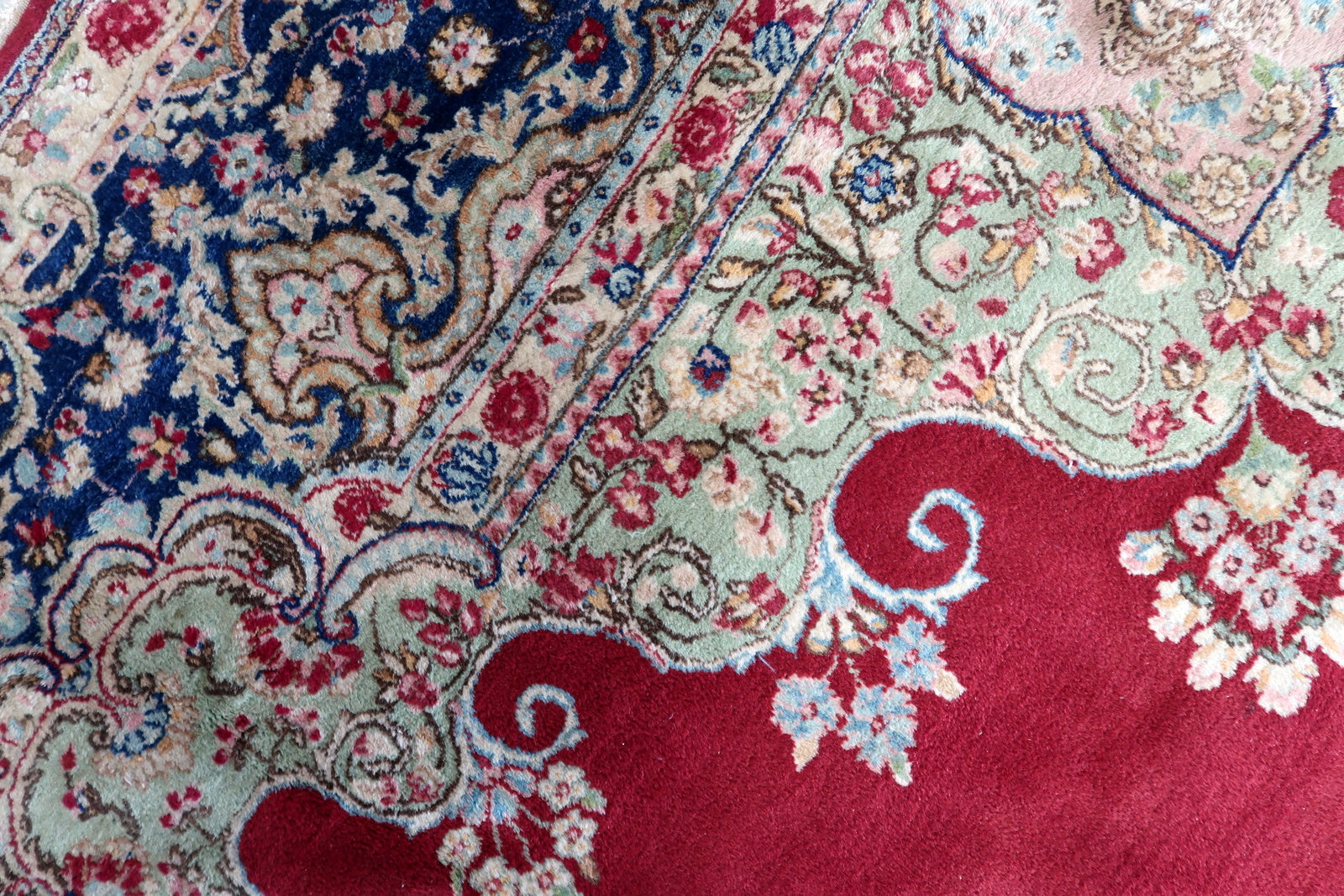 Persian Kerman rug detail, floral vines and arabesque patterns in rich tones