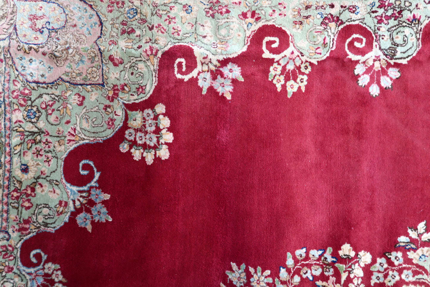 Vintage Persian Kerman rug corner detail, showcasing craftsmanship and patina