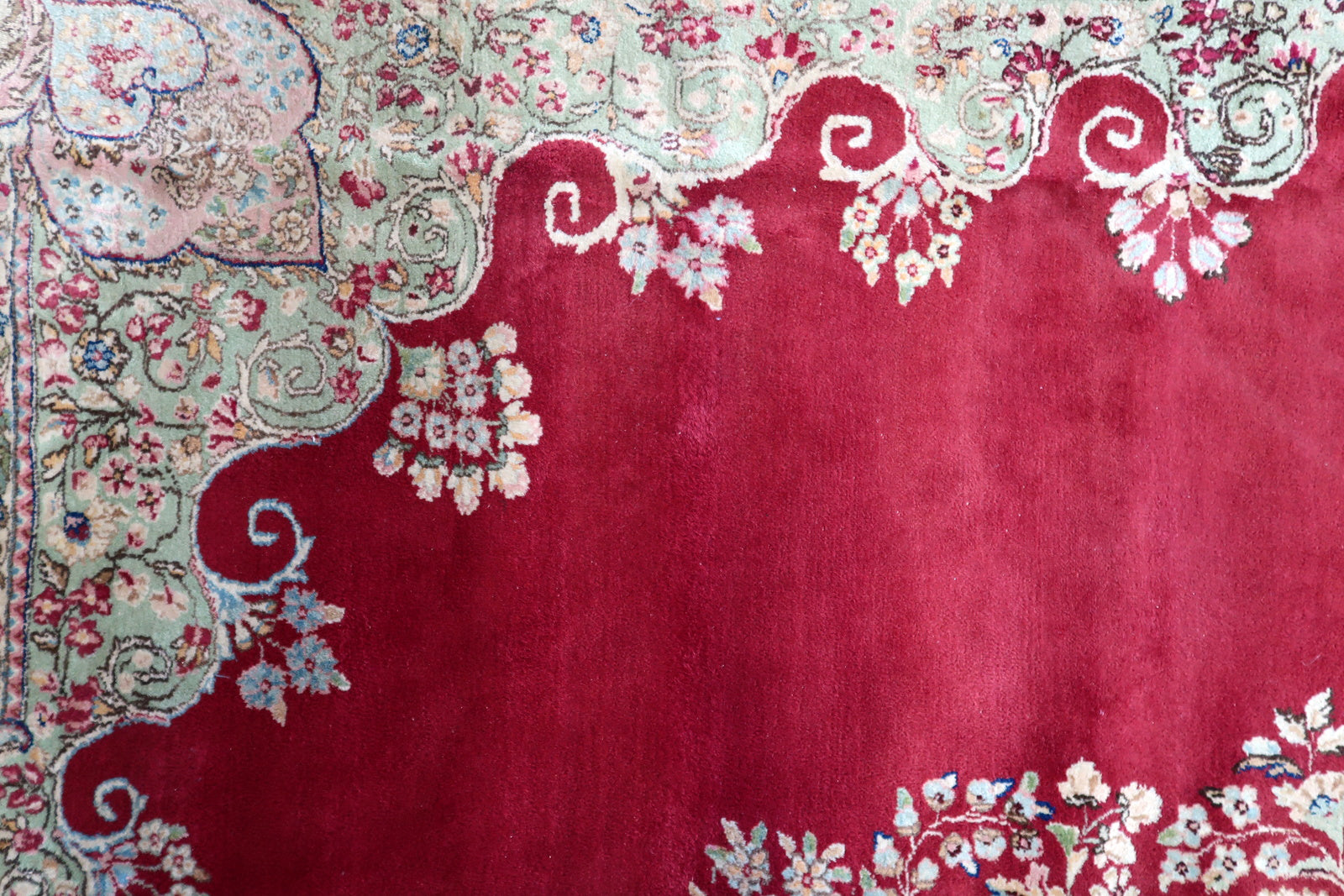 Vintage Persian Kerman rug corner detail, showcasing craftsmanship and patina