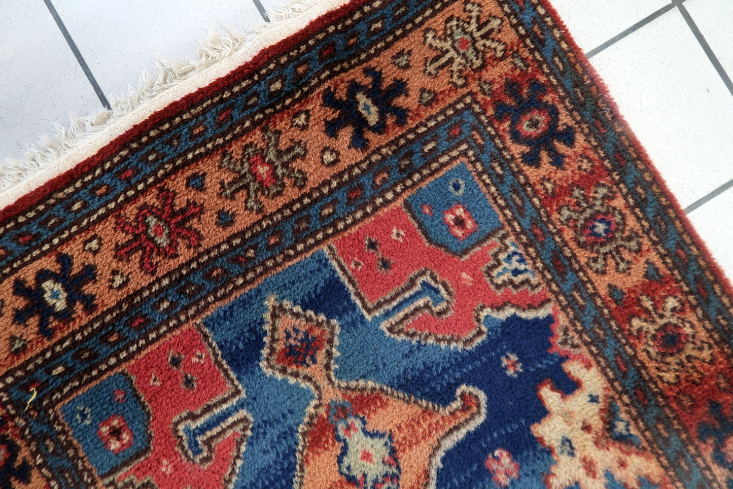 Vintage German rug close-up, showing soft wool pile and geometric motifs
