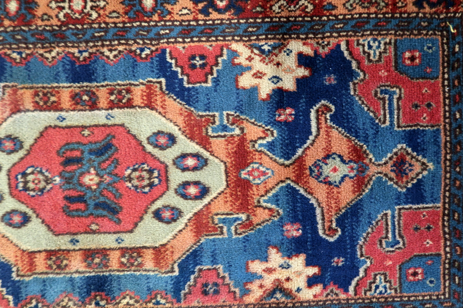 Vintage tribal style rug detail, geometric patterns in rich earthy tones