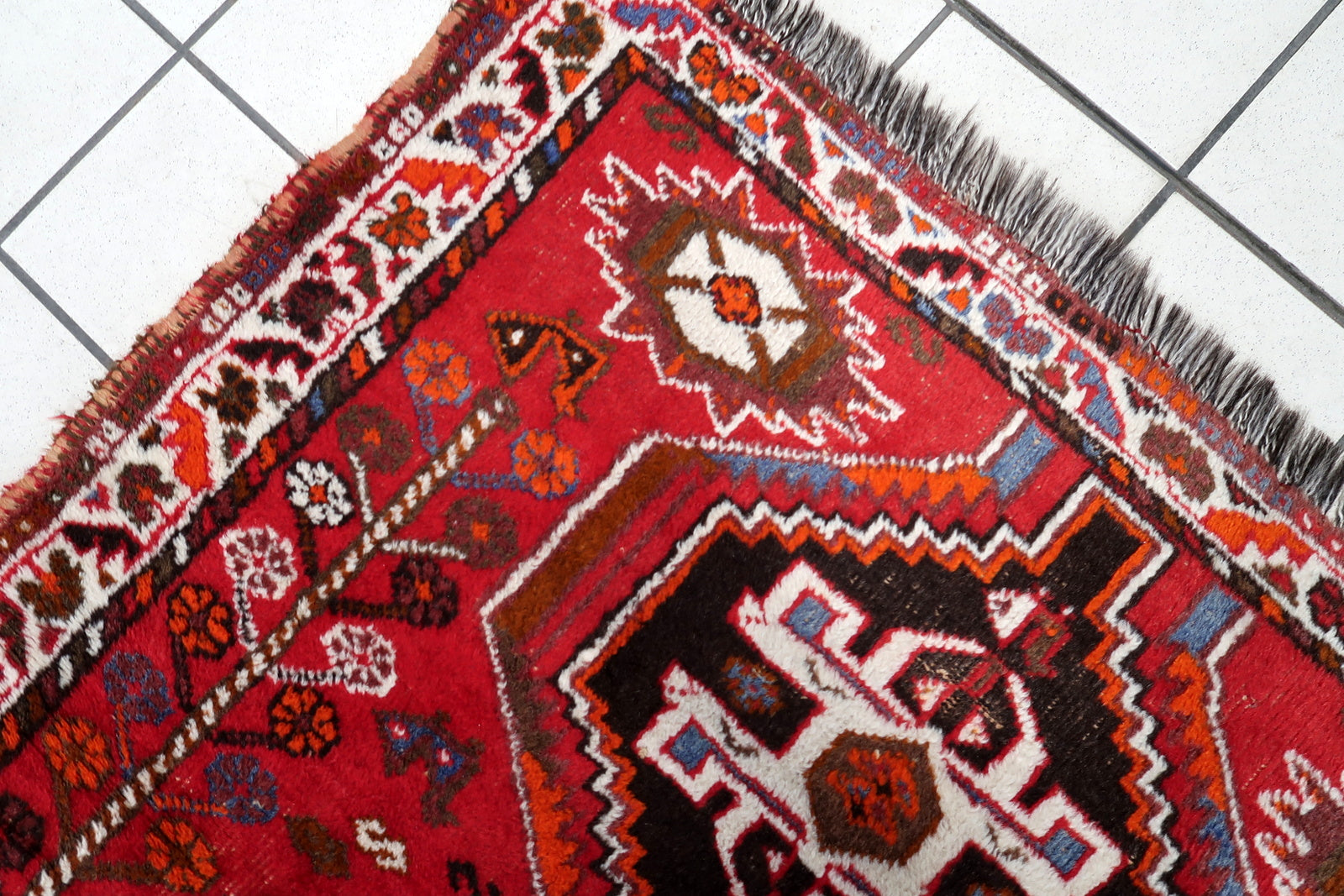Vintage Shiraz rug close-up, showing hand-knotted wool texture and pattern