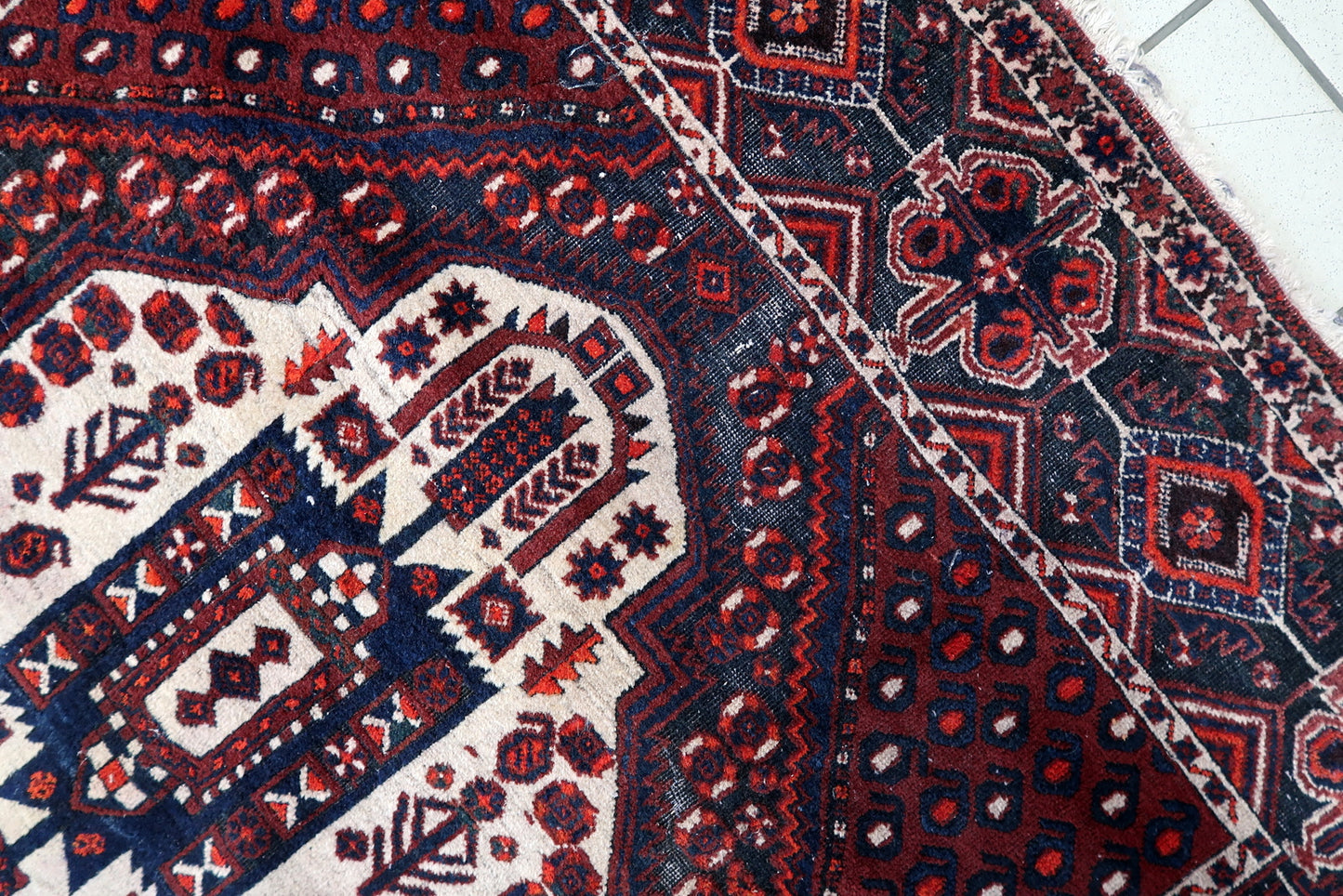 Vintage Afshar rug close-up, showing hand-knotted wool texture and pattern