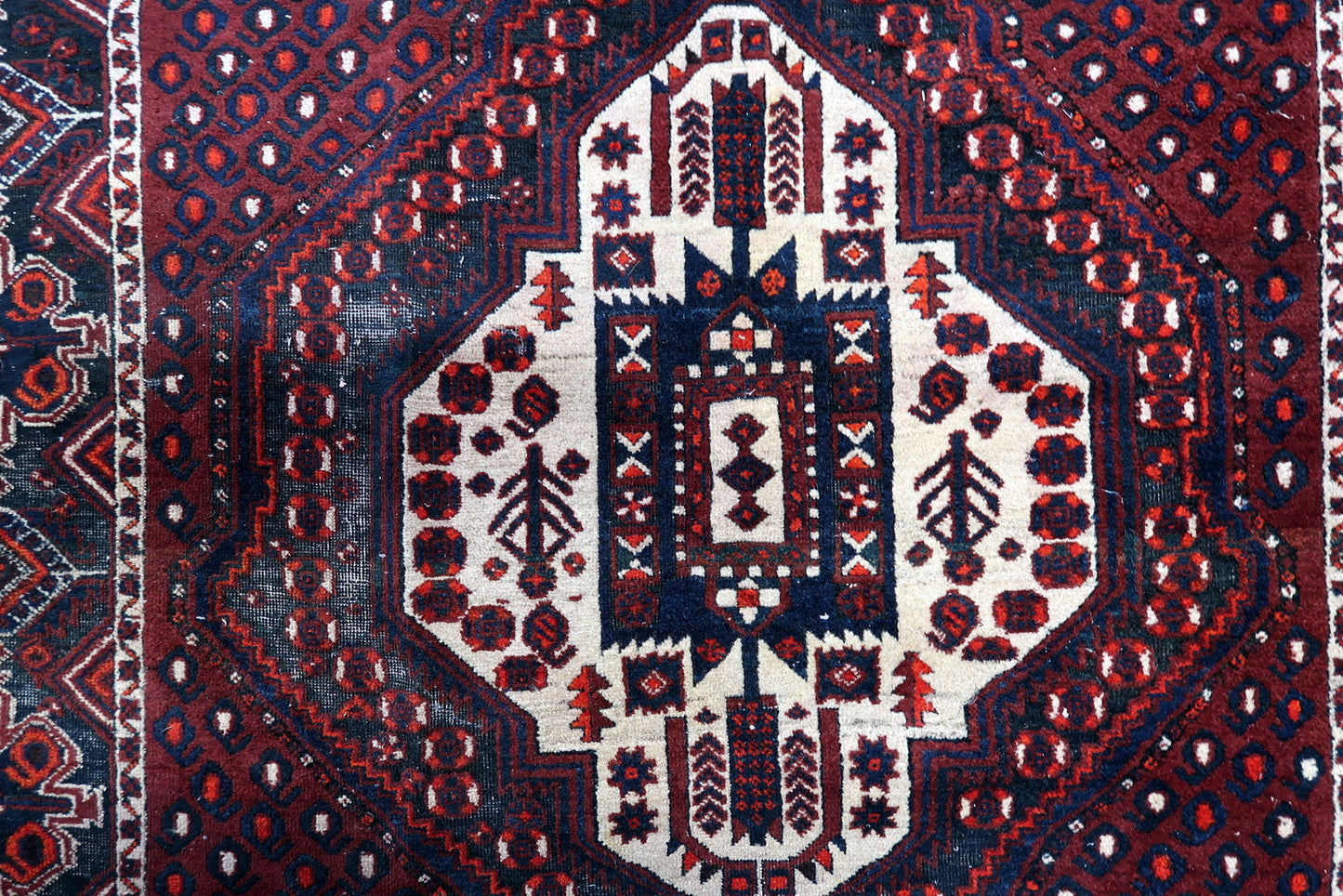 Handmade Afshar rug detail, stylized tribal patterns and angular design