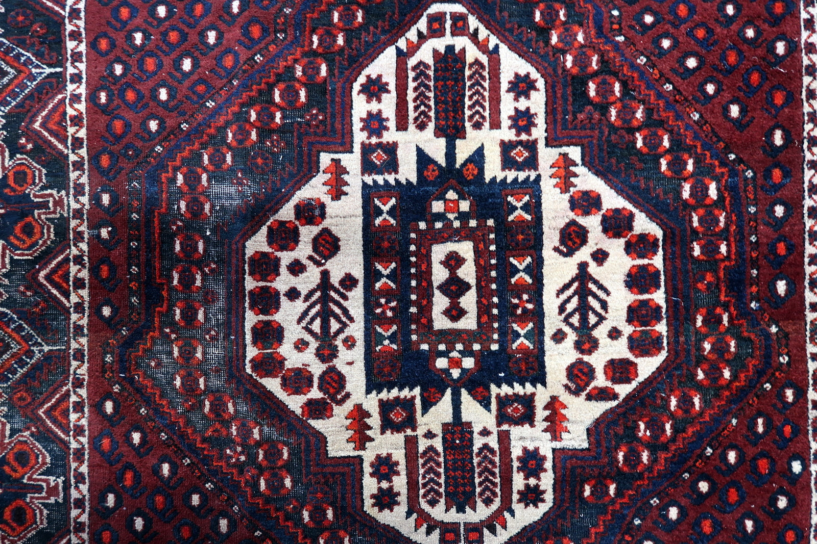 Handmade Afshar rug detail, stylized tribal patterns and angular design