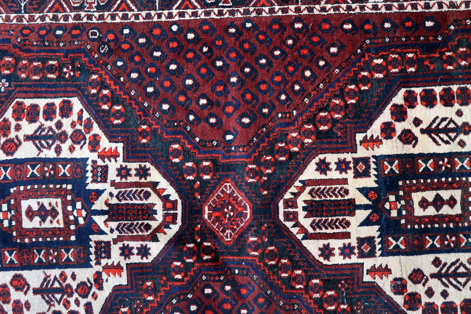 Afshar rug corner detail, showcasing craftsmanship and aged patina
