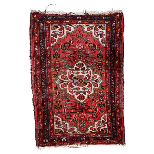 Handmade antique Persian Hamadan wool rug from the 1920s featuring a central floral medallion on a rich red field, measuring 3.4 by 4.8 feet.

