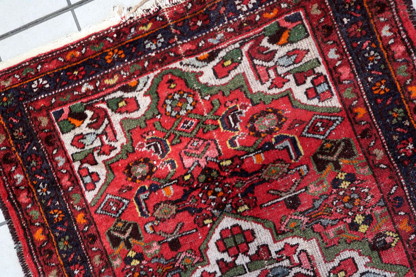 Antique red Persian Hamadan rug with detailed medallion design, hand-knotted wool on a cotton foundation, showing beautiful age-related patina.

