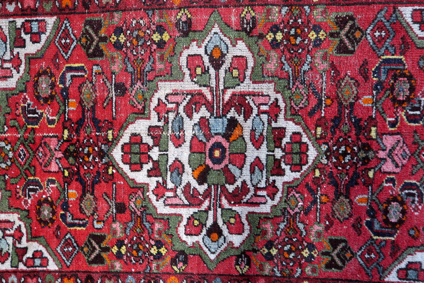 Small vintage Persian Hamadan accent rug from the 1920s, 3.4 x 4.8 feet, with a warm red background and multi-layered floral borders.

