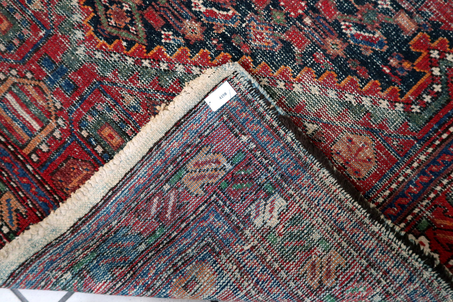 A beautifully worn 1920s Persian Hamadan rug with a dense all-over geometric design, softened by a century of gentle fading and use.

