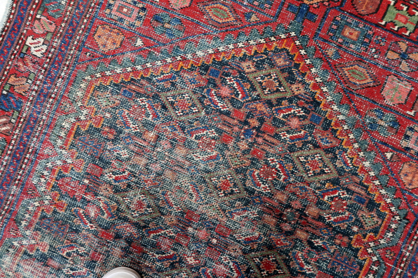 Small antique Persian Hamadan runner-style rug in elongated format, featuring faded geometric design and desirable vintage distressed patina.

