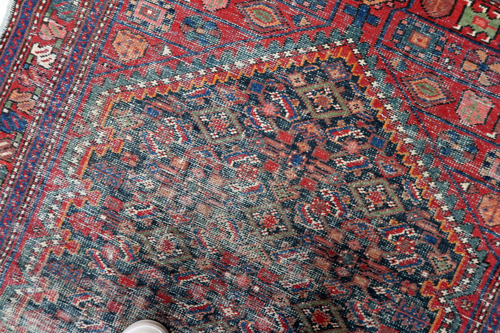 Small antique Persian Hamadan runner-style rug in elongated format, featuring faded geometric design and desirable vintage distressed patina.

