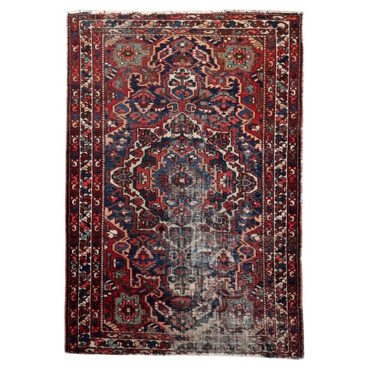 Handmade antique Persian Hamadan rug from the 1920s with distressed finish, featuring a bold geometric medallion design in deep navy blue and warm red, measuring 4.3 by 6.5 feet.

