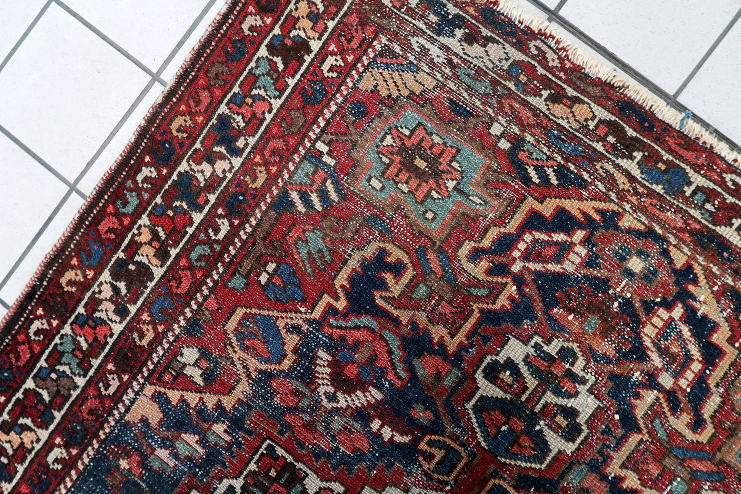 Antique distressed Persian Hamadan rug circa 1920s, hand-knotted wool on cotton foundation, displaying rich navy and red color palette with softened geometric details.

