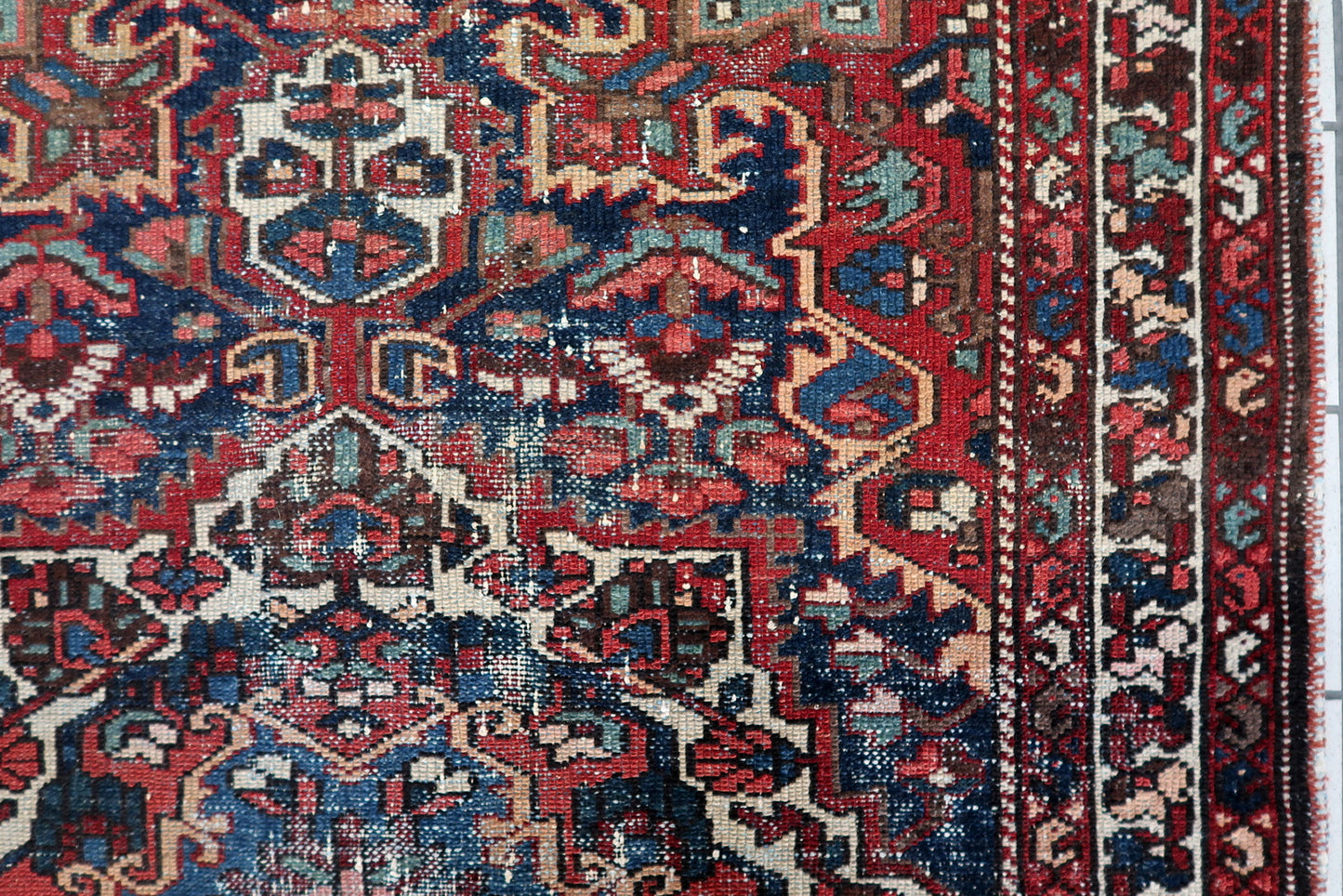 Full composition of a vintage Persian Hamadan carpet from the 1920s, 4.3 x 6.5 ft, with a strong central geometric medallion and multiple decorative borders.

