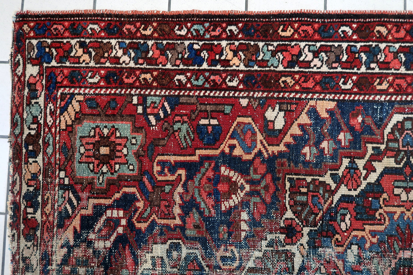 1920s antique Persian Hamadan carpet geometric medallion tribal motifs navy blue red ivory muted green.

