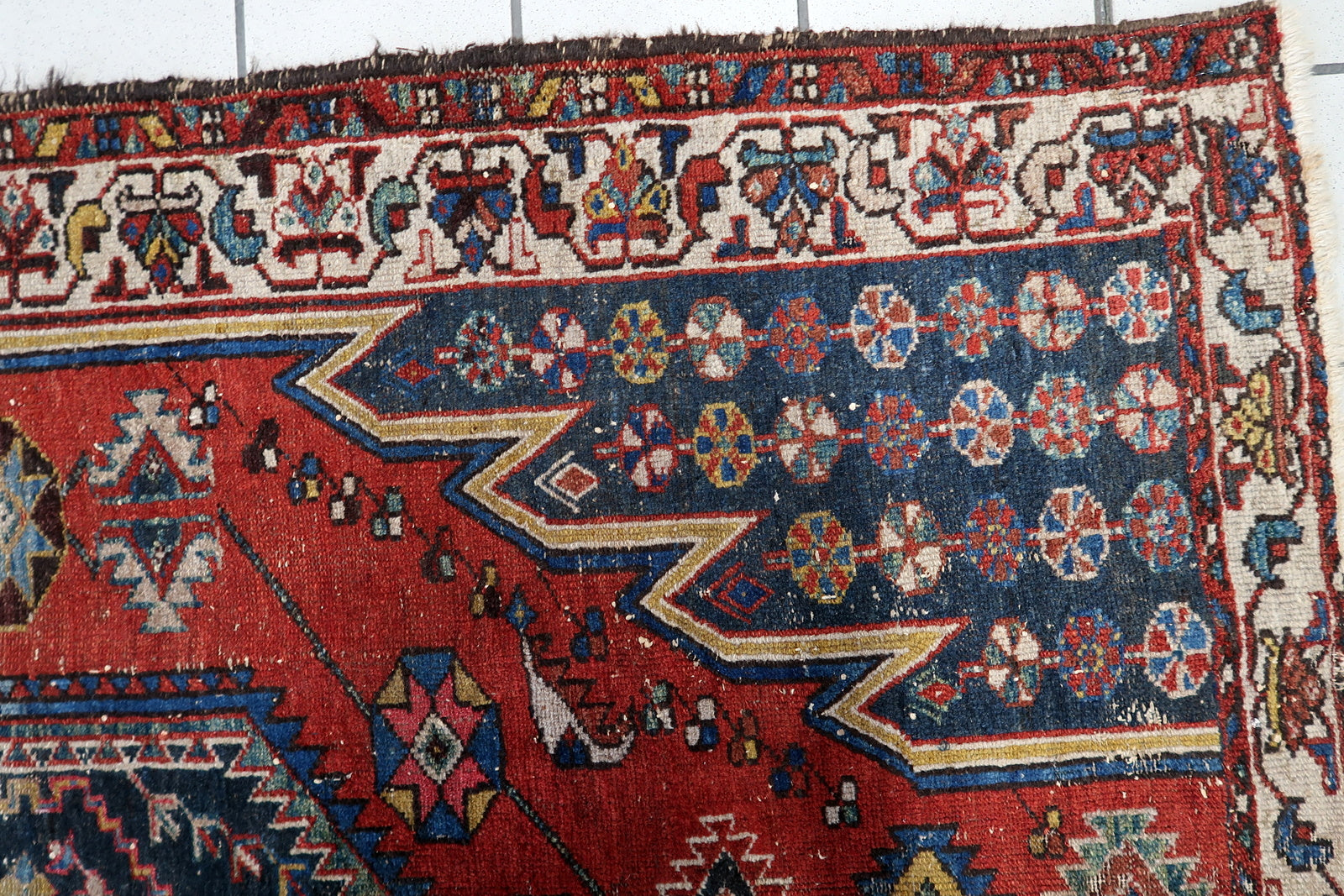 Early 20th-century Persian Hamadan carpet from the 1920s, featuring a beautifully aged patina, softened geometric patterns, and a structurally sound condition for everyday use.

