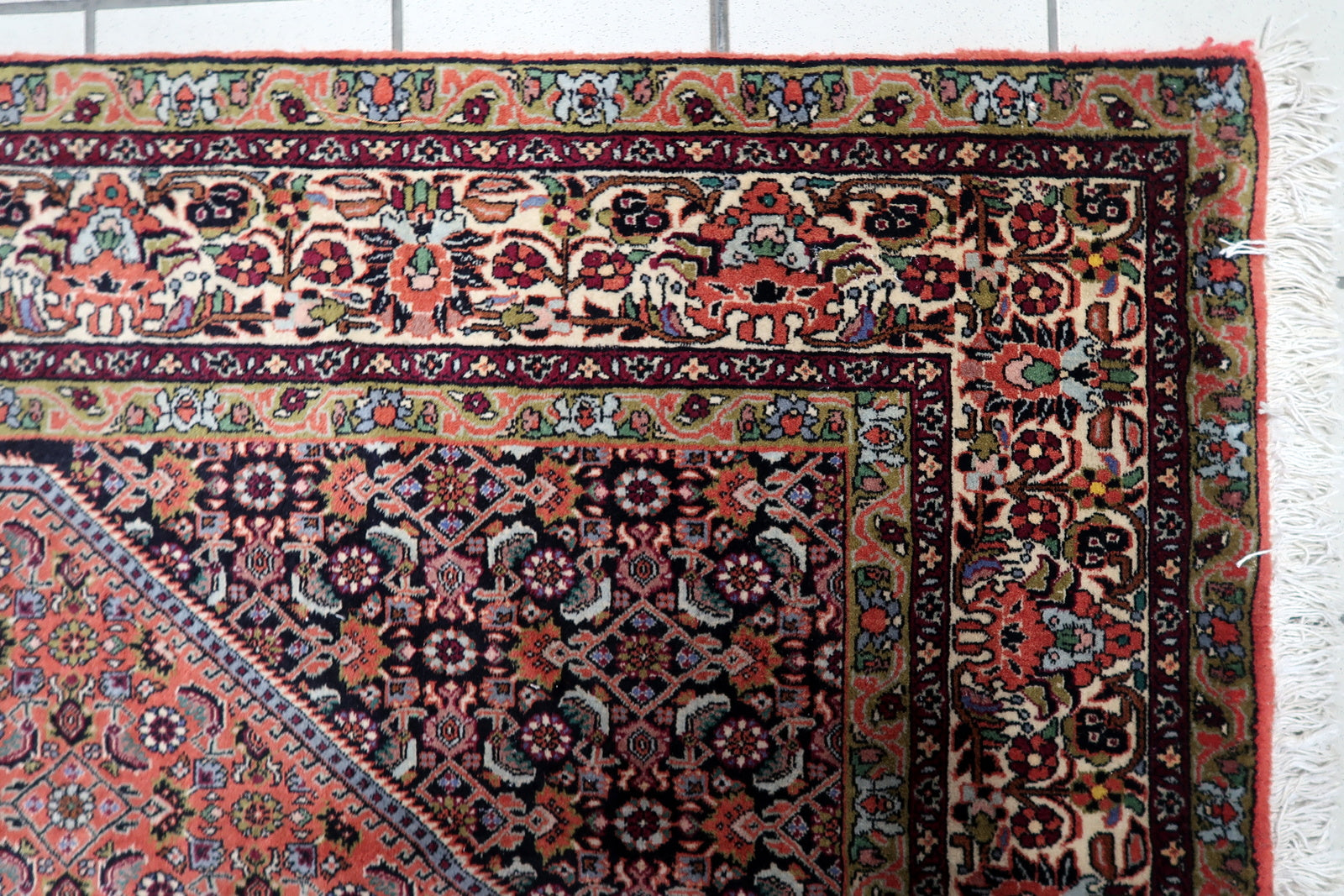 Mid-20th-century Persian Bidjar rug, 1950s, featuring a rich red field, navy blue borders, and a balanced composition of traditional floral and geometric patterns typical of Bidjar craftsmanship.

