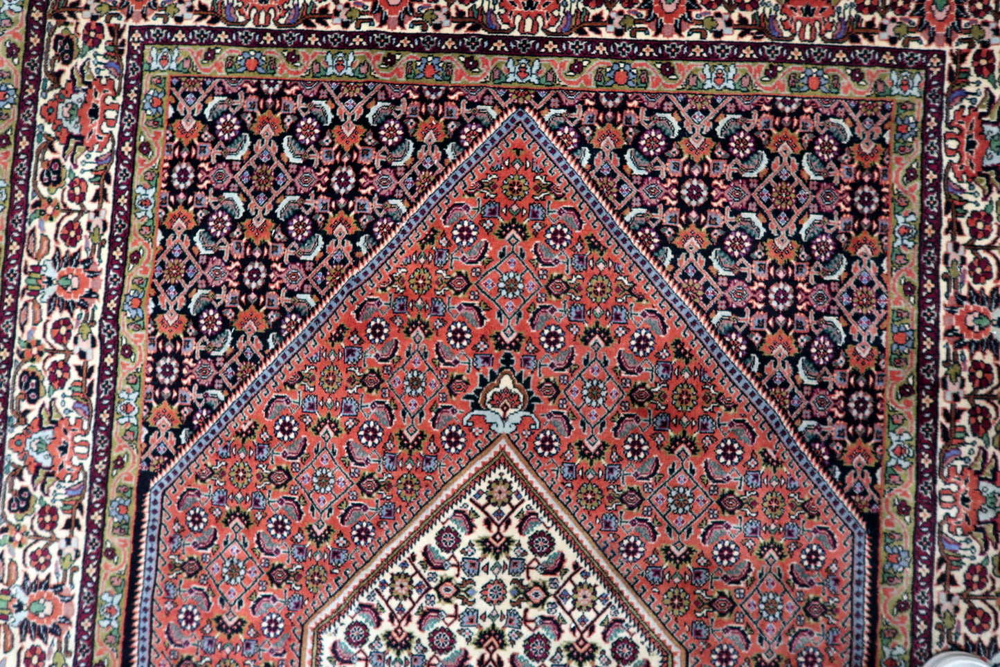 Durable vintage area rug with a central medallion and intricate detailing, ideal for adding warmth and character to a living room, office, or high-traffic interior space.

