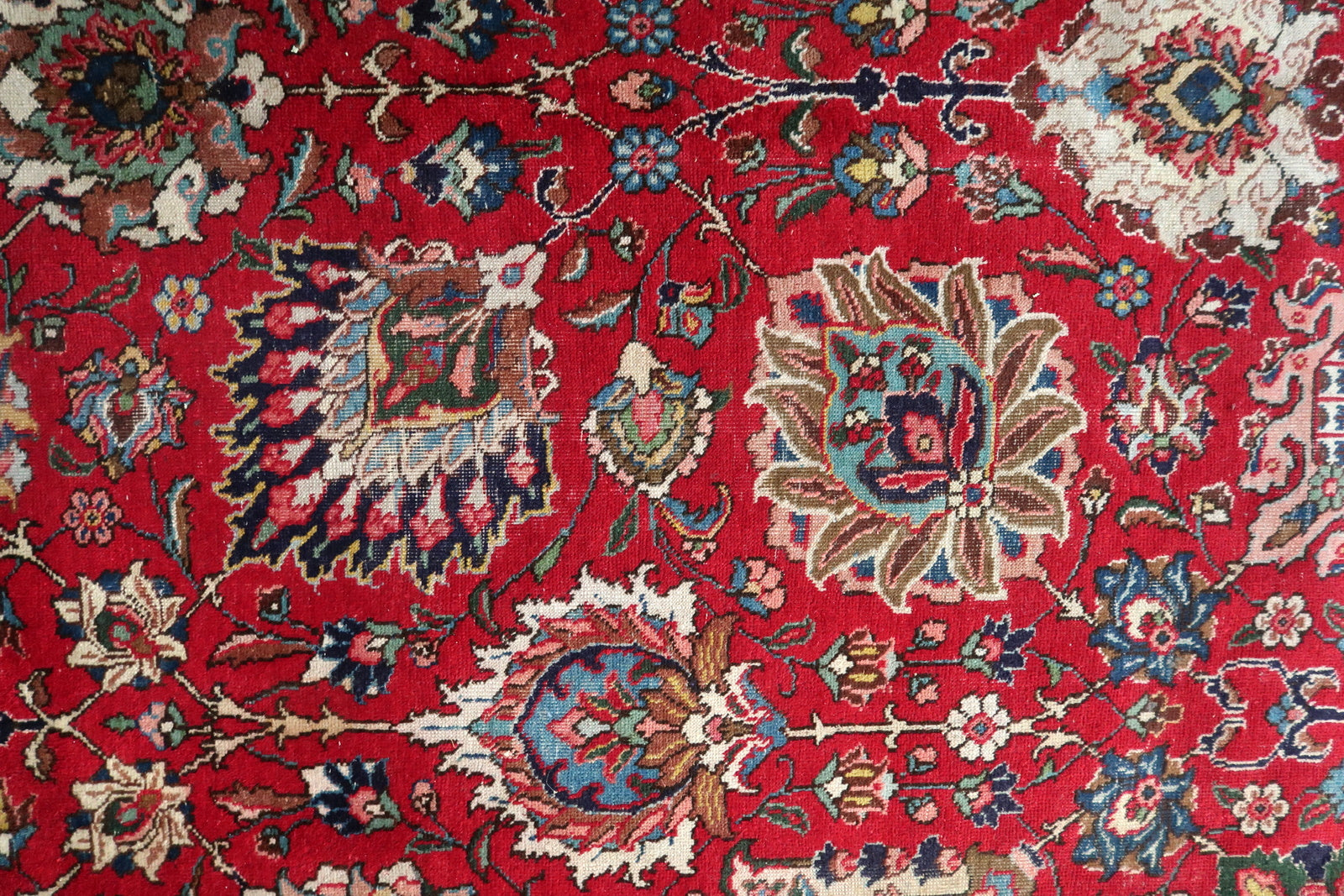 Full perspective of an antique Tabriz rug displayed in a formal interior, demonstrating its generous 9'11" × 13'2" size suitable for anchoring a dining room, grand living room, or library.

