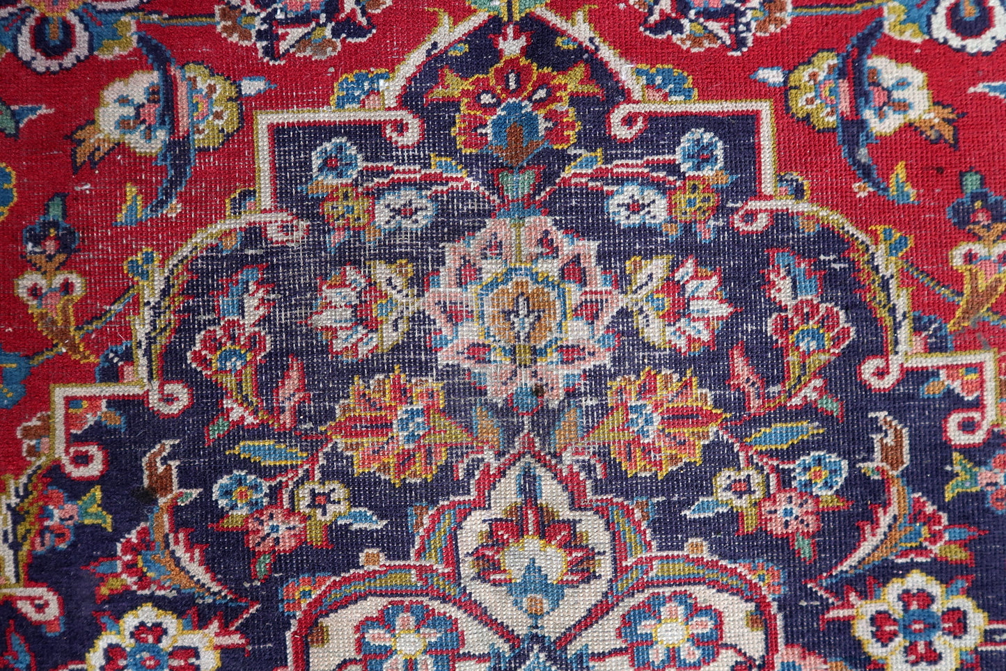 Full view of an antique Persian medallion Kashan rug laid flat, showing its rectangular shape, navy main border, vivid sky blue guard borders, and the precise medallion drawing with clarity of ivory outline and perfect symmetry.

