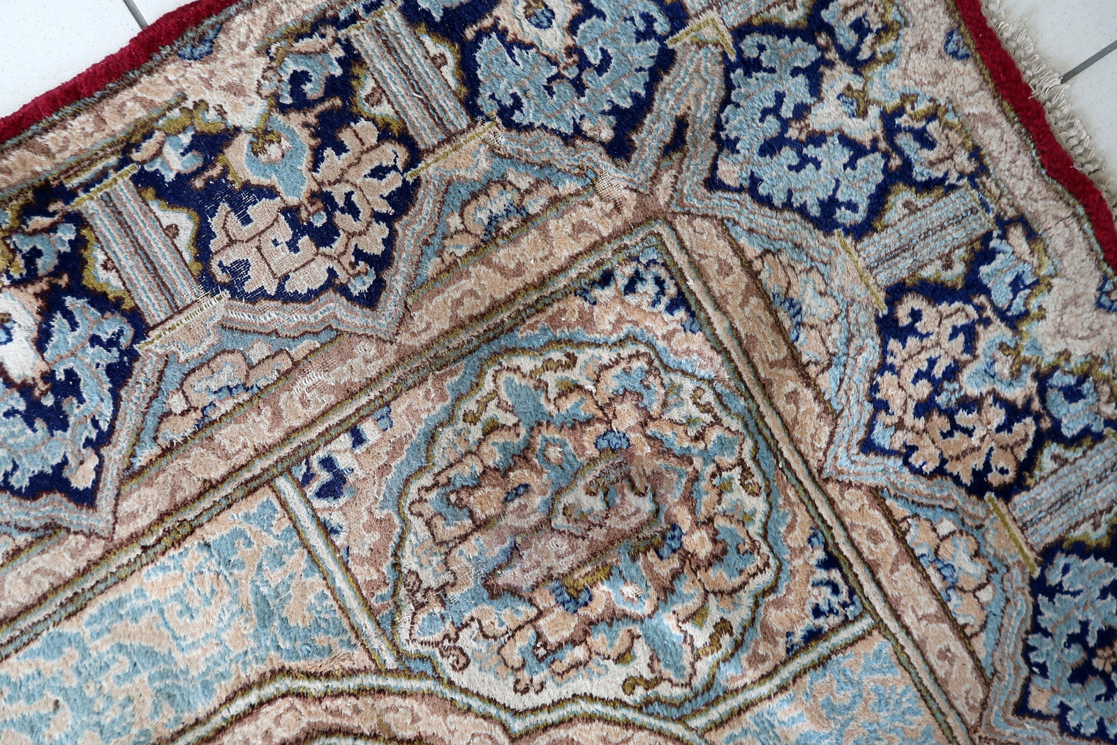 Full perspective of an antique Kerman rug displayed in a formal interior, demonstrating its generous 7'9" × 9'11" size suitable for anchoring a living room or dining room.

