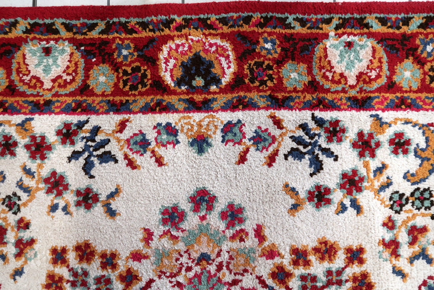 Full perspective of a vintage Savonnerie-style rug displayed in a formal interior, demonstrating its generous 6'7" × 9'6" size suitable for anchoring a living room, dining room, or bedroom.

