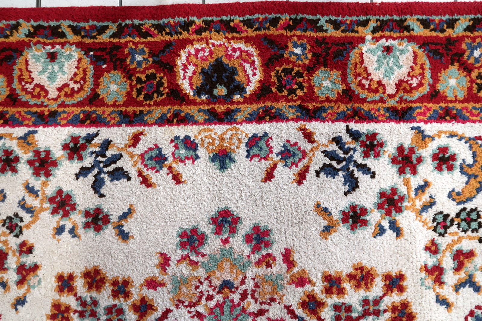 Full perspective of a vintage Savonnerie-style rug displayed in a formal interior, demonstrating its generous 6'7" × 9'6" size suitable for anchoring a living room, dining room, or bedroom.

