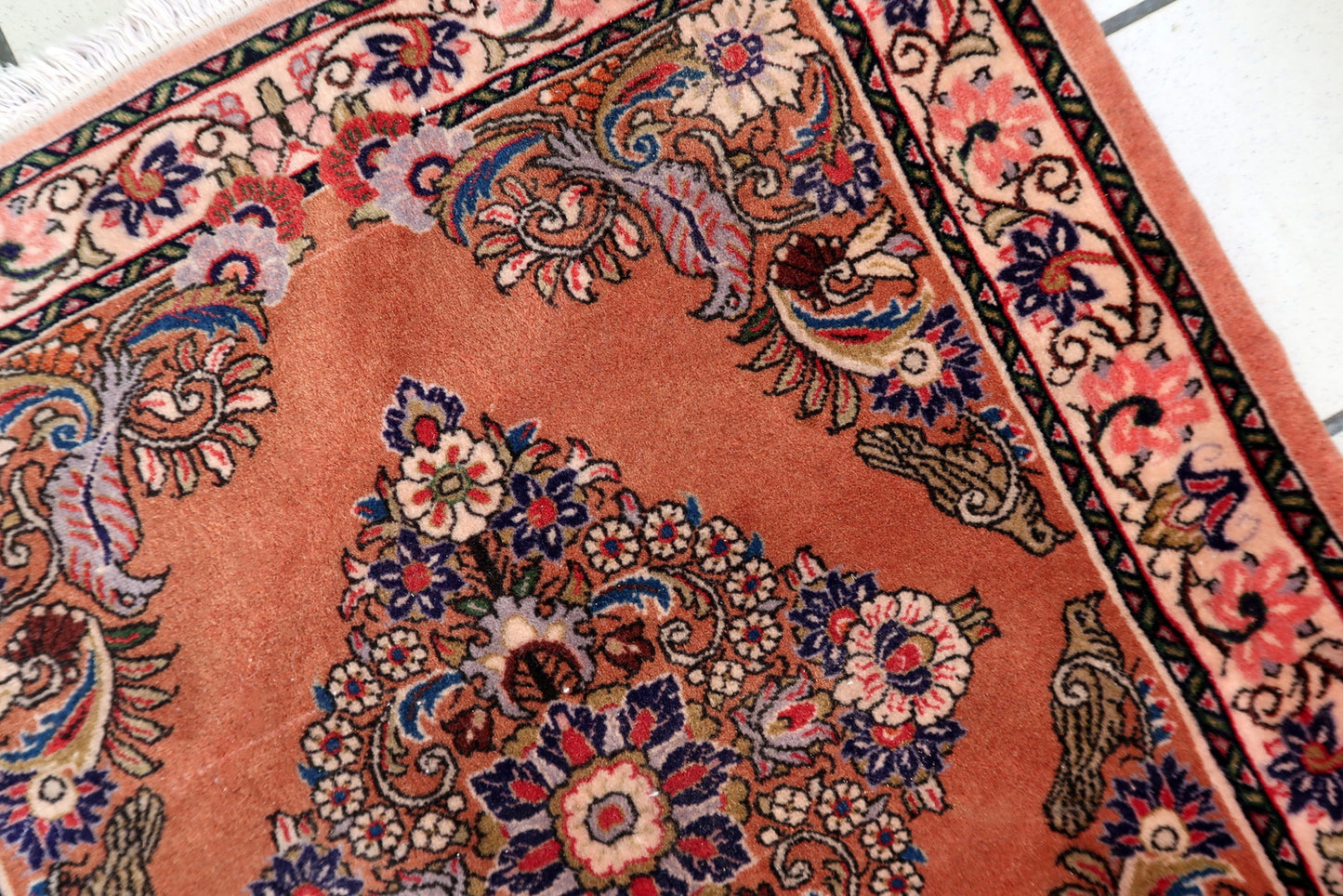 Rose‑field Sarouk rug with multi‑lobed diamond medallion and detailed floral motifs

