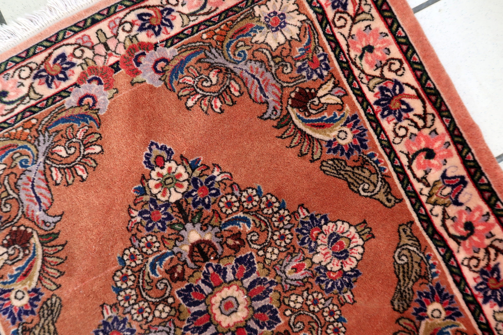 Rose‑field Sarouk rug with multi‑lobed diamond medallion and detailed floral motifs

