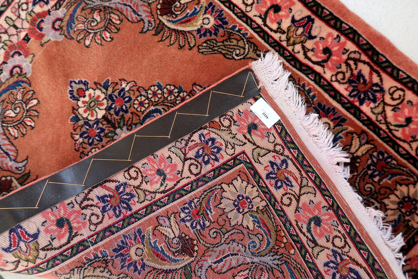 Vintage Sarouk accent rug in terracotta tones with navy guard borders

