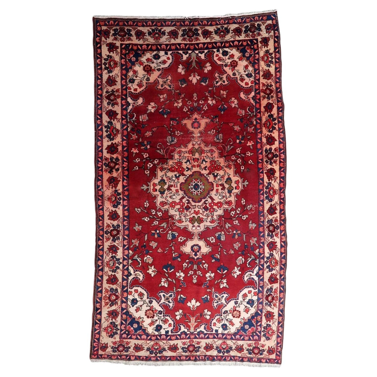 Antique 1920s Persian Malayer wool rug featuring a central red floral medallion and detailed arabesque field.