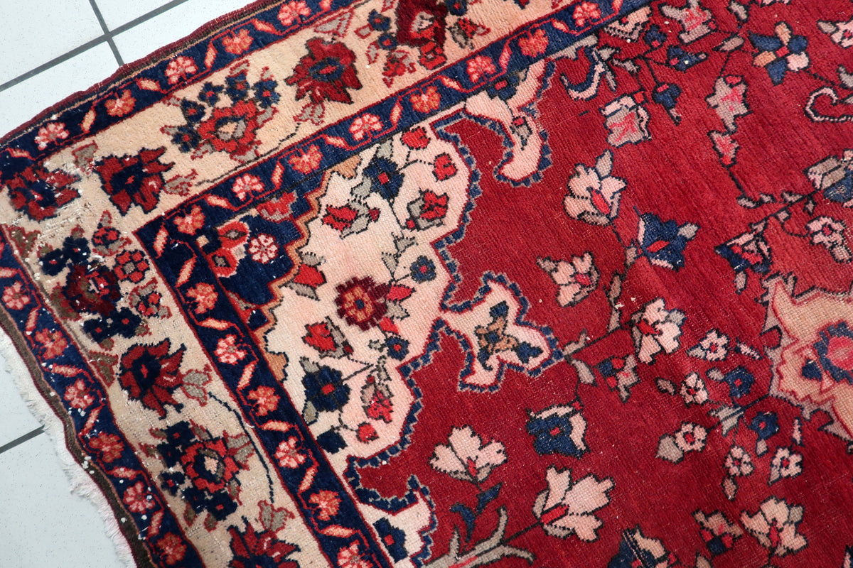 Low-profile pile height demonstrating authentic vintage patina and age-appropriate character on a 100-year-old Malayer rug.