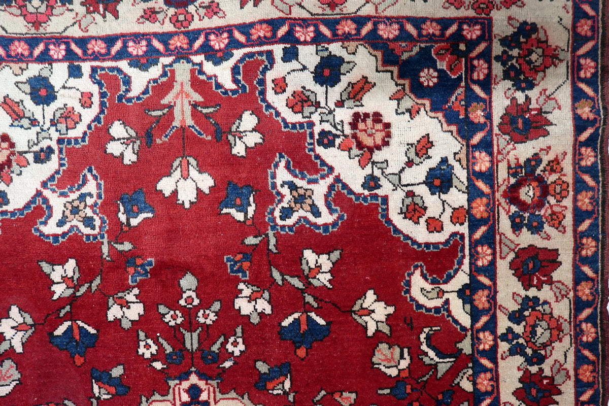 Low-profile hand-spun wool pile woven with rich madder root red, navy indigo blue, and ivory accents.