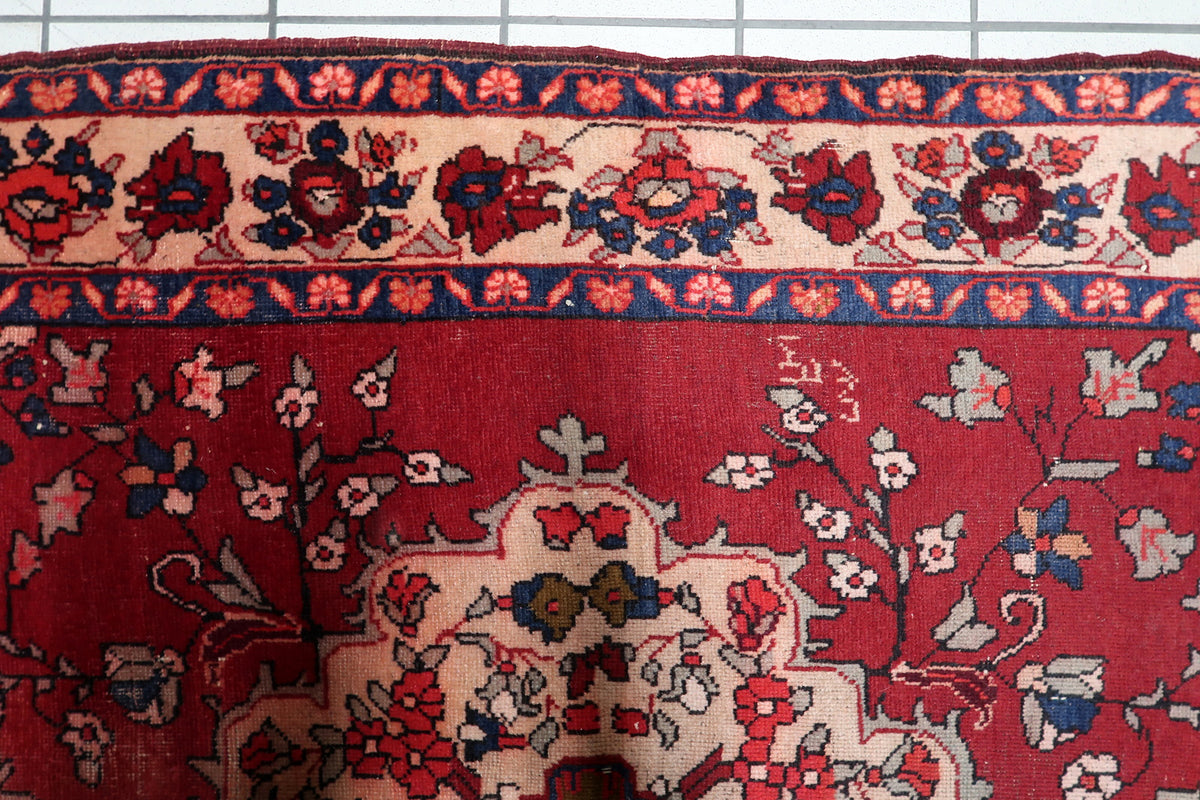 Multi-band border design featuring repeating rosettes, floral meanders, and Herati-inspired motifs in dark blue and red.