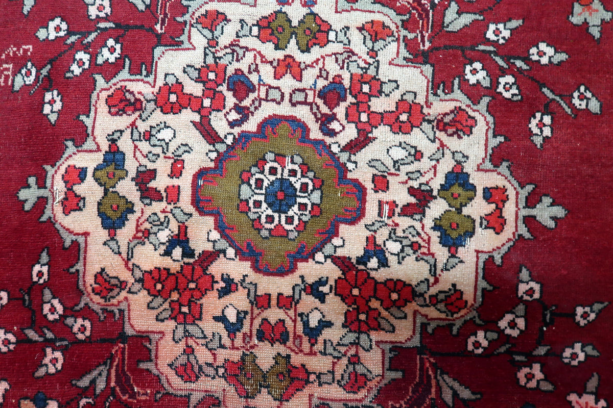 Tight hand-knotted cotton warp and wool pile weave structure visible on the back of an antique Persian carpet.