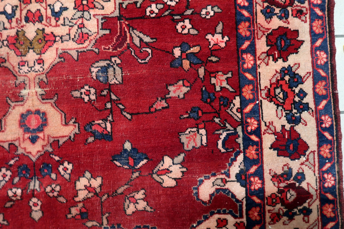 Original bound selvedge edges and subtle natural fringe finishing on an authentic Persian wool rug.